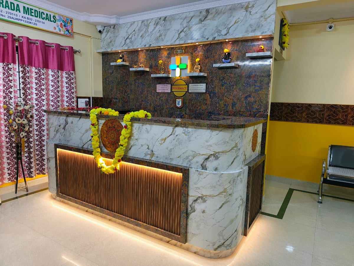 Reception desk with marble-patterned counter, floral garland, curtains and seating