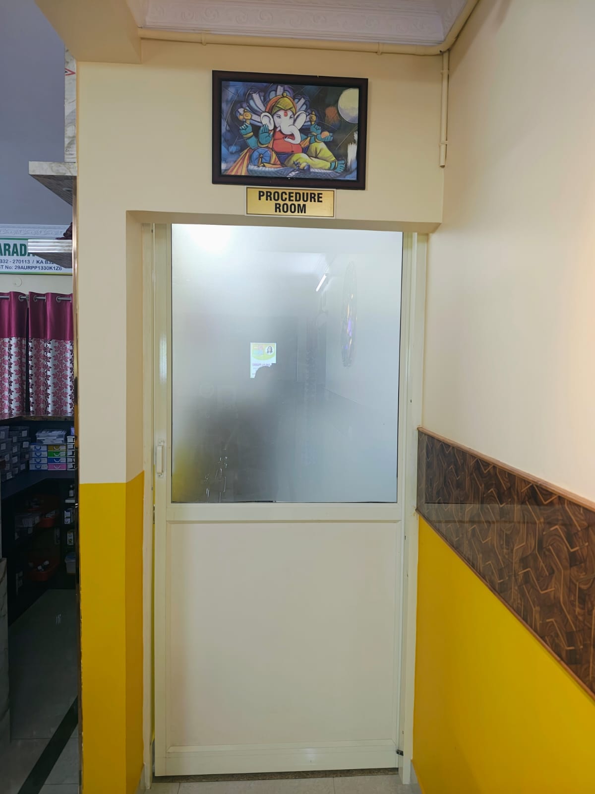 Frosted glass door marked Procedure Room with framed artwork above