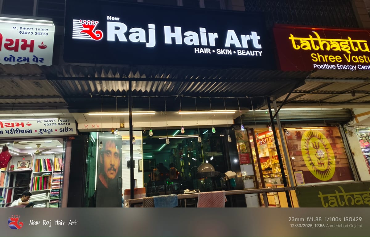 Street-facing Raj Hair Art storefront with illuminated signage and glass entrance