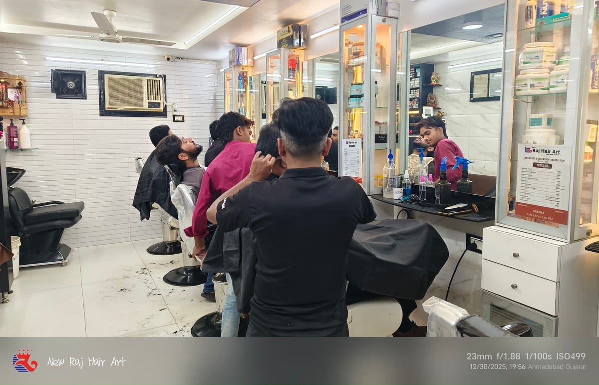Hair stylists serving clients at mirrored styling stations in the salon