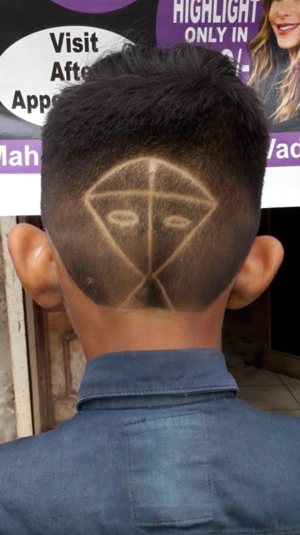 Back of a head with a geometric shaved hair design