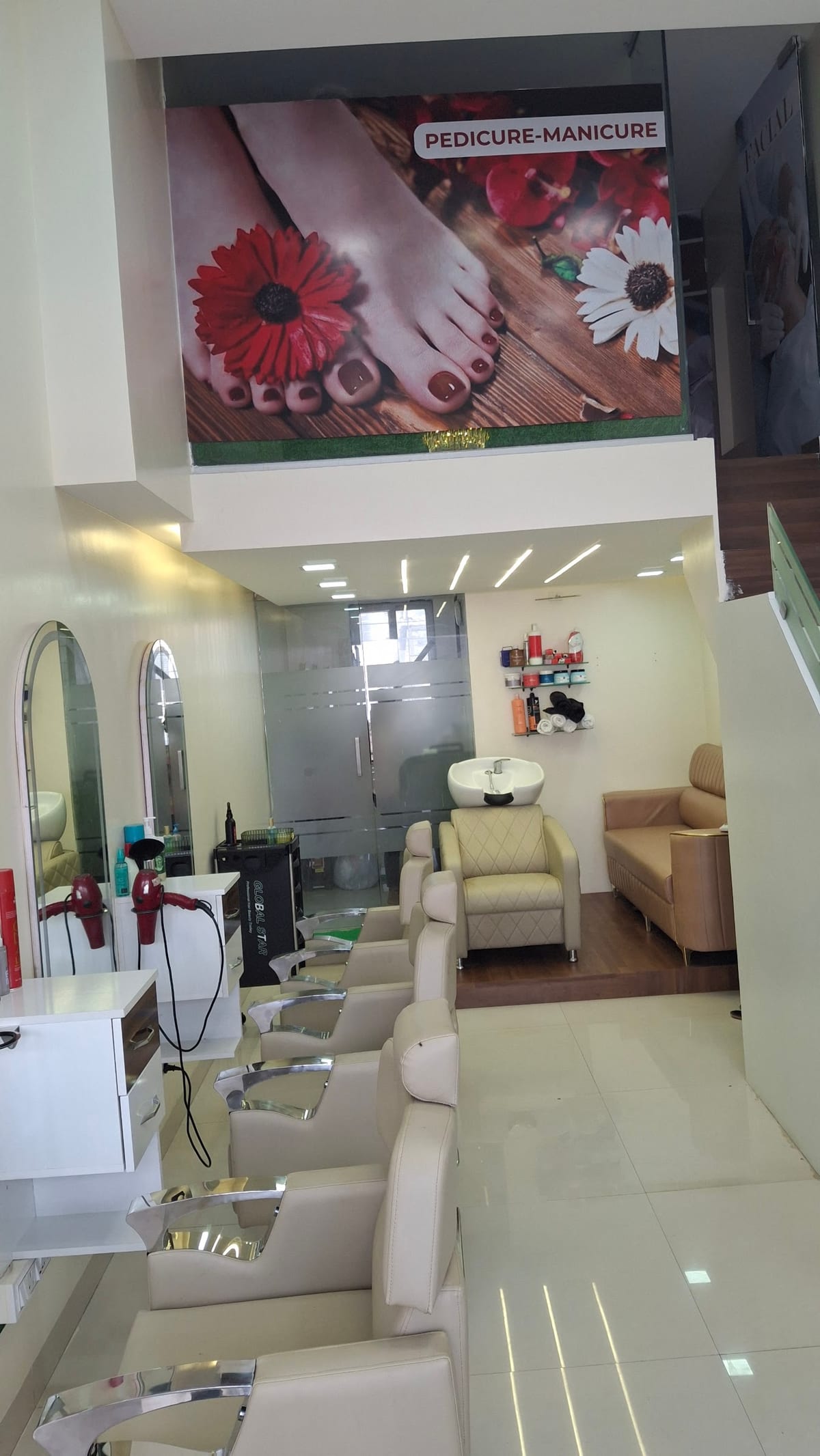 Nail salon interior with manicure and pedicure chairs and wall poster