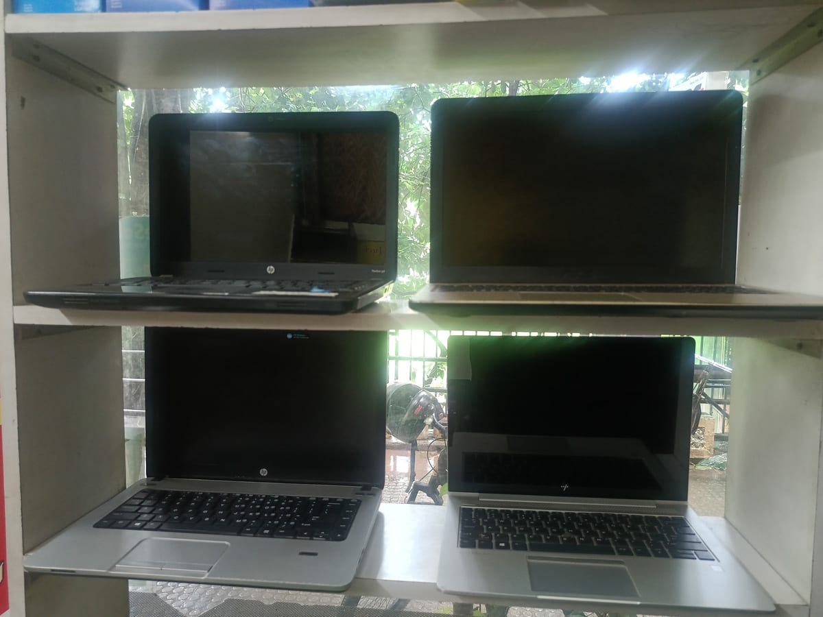 Retail shelving stocked with boxed keyboards, speakers, cables and accessories