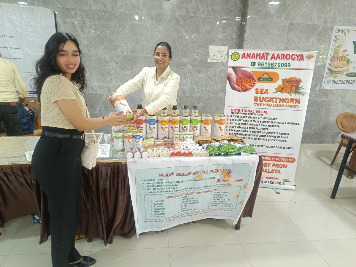 Two women presenting sea buckthorn products at a display table