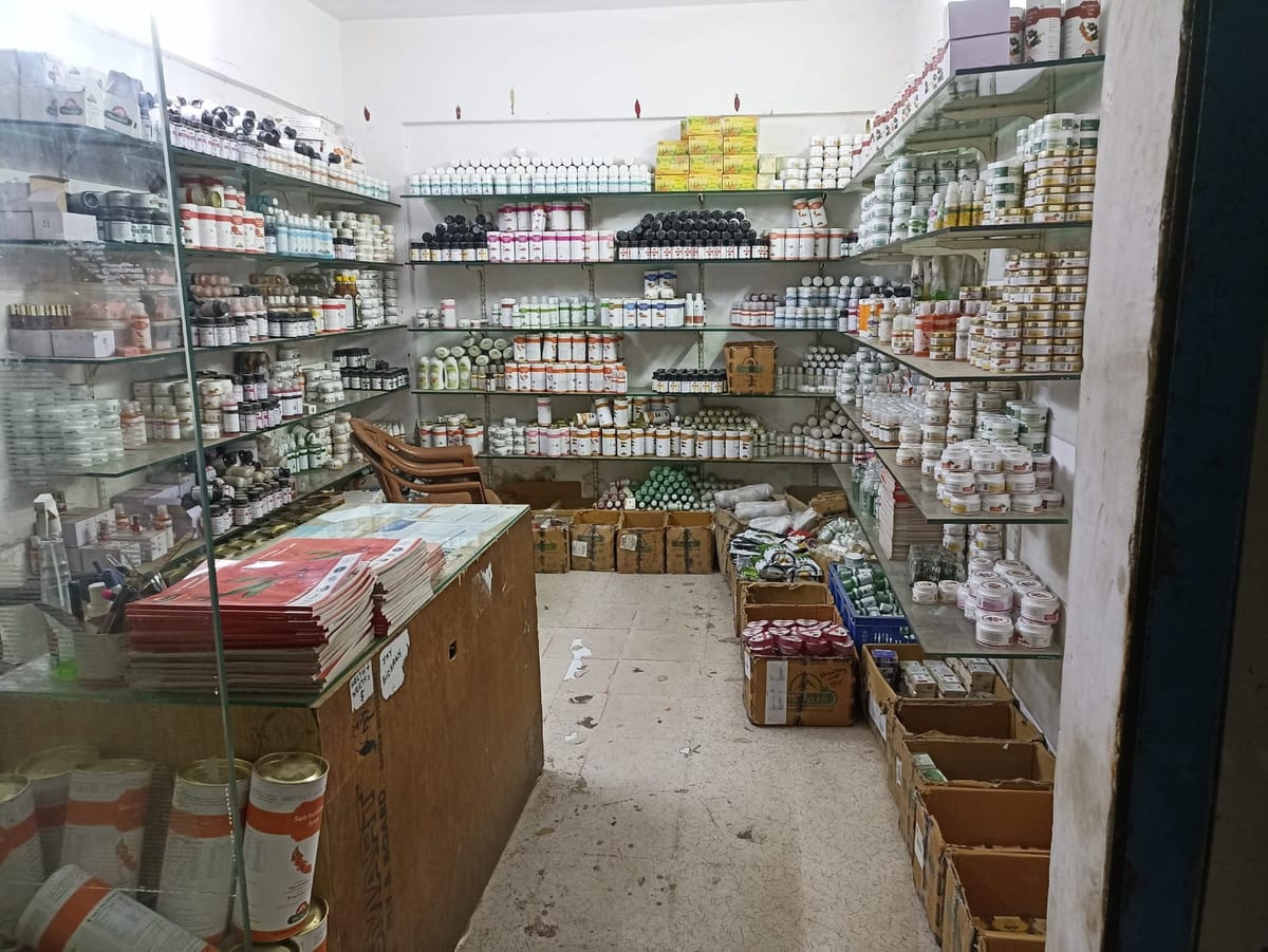 Shop interior with stocked shelves and glass display cases