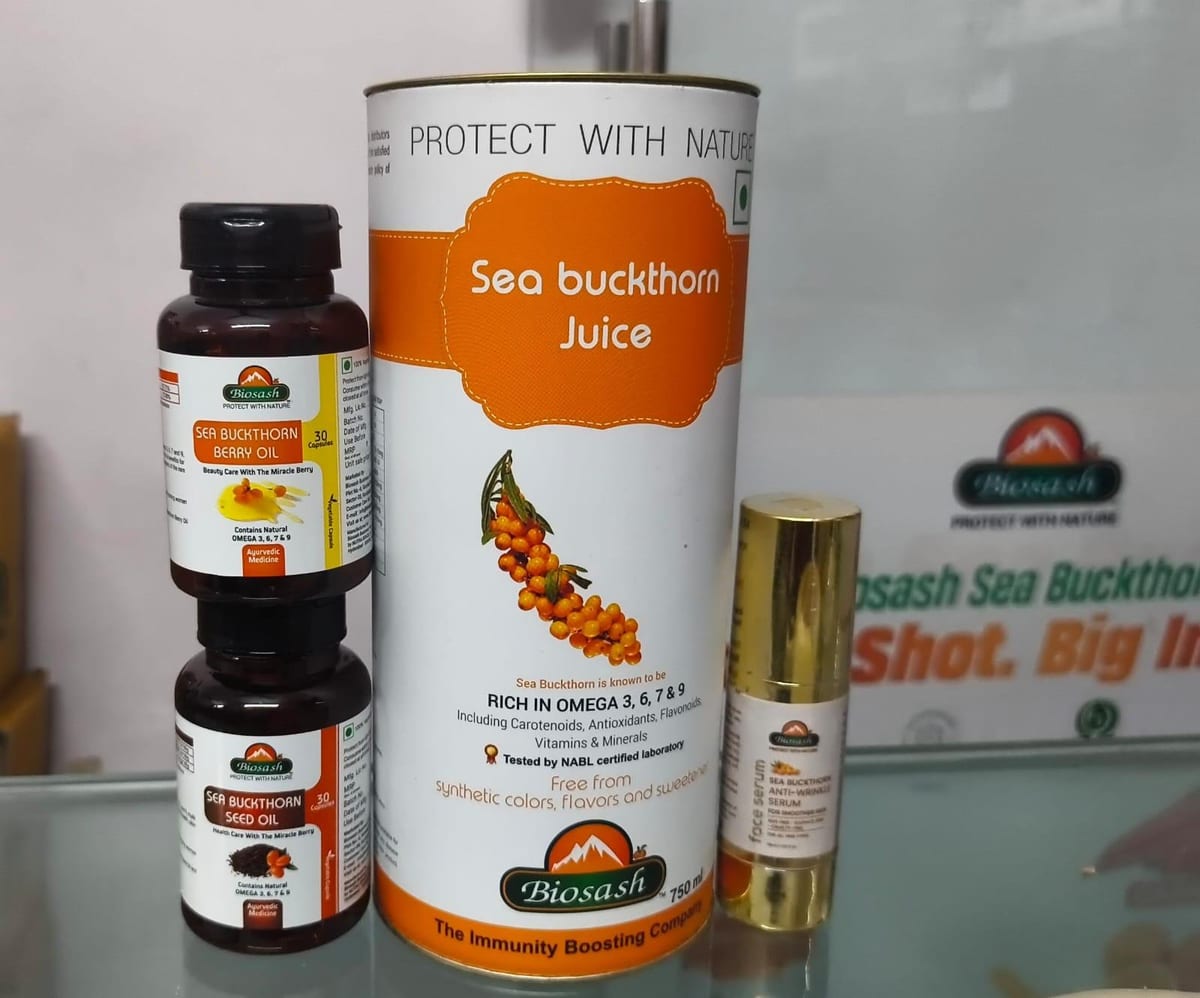Sea buckthorn juice canister, capsules and small bottle displayed together