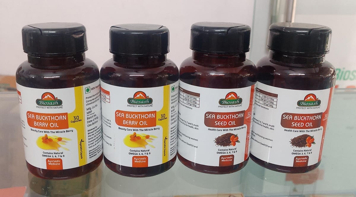 Four amber bottles of sea buckthorn berry oil and seed oil