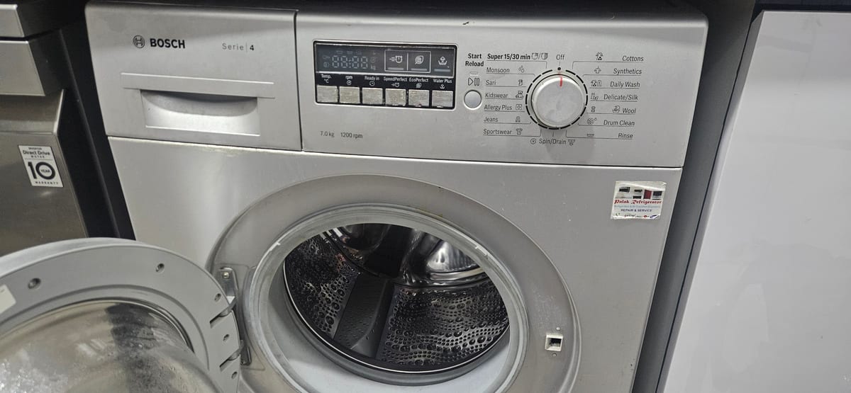 Bosch front-loading washing machine with its door open showing the drum