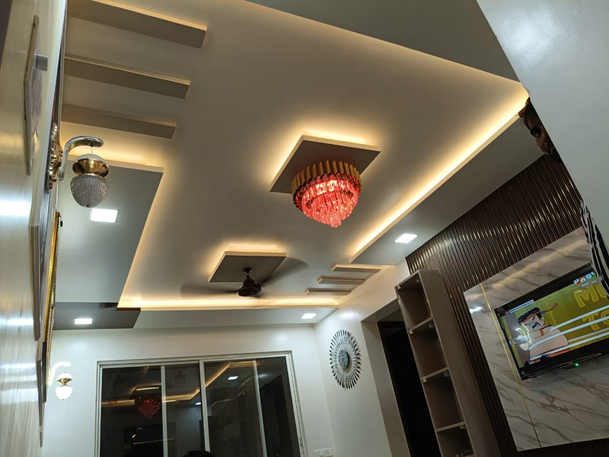 Interior room with recessed lights, chandelier, ceiling fans and a wall-mounted TV