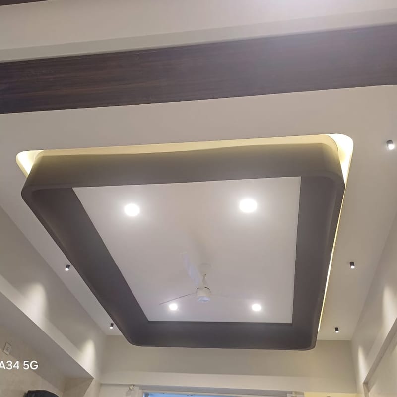 Ceiling with a large decorative rectangular panel and recessed lights