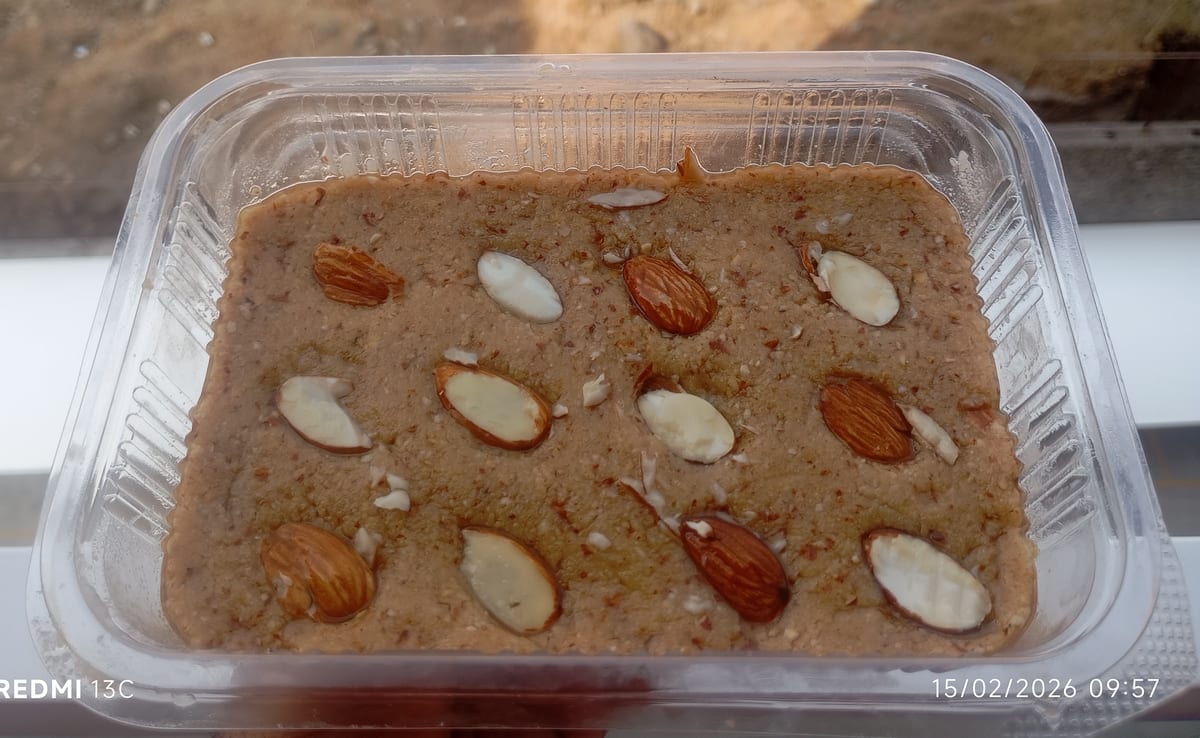 Nut-topped paak dessert in a clear plastic container