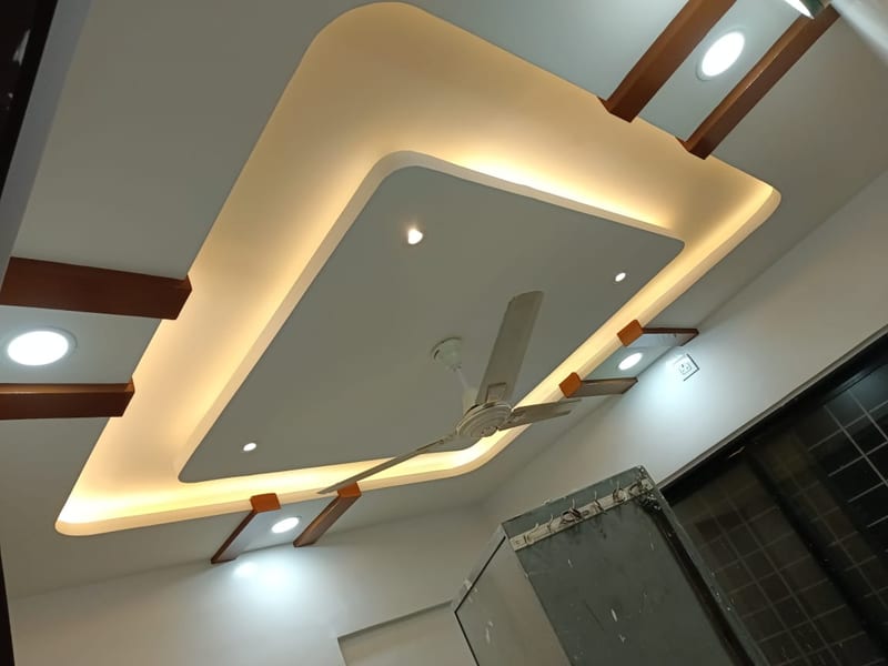 Decorative layered recessed ceiling with spotlights and a ceiling fan