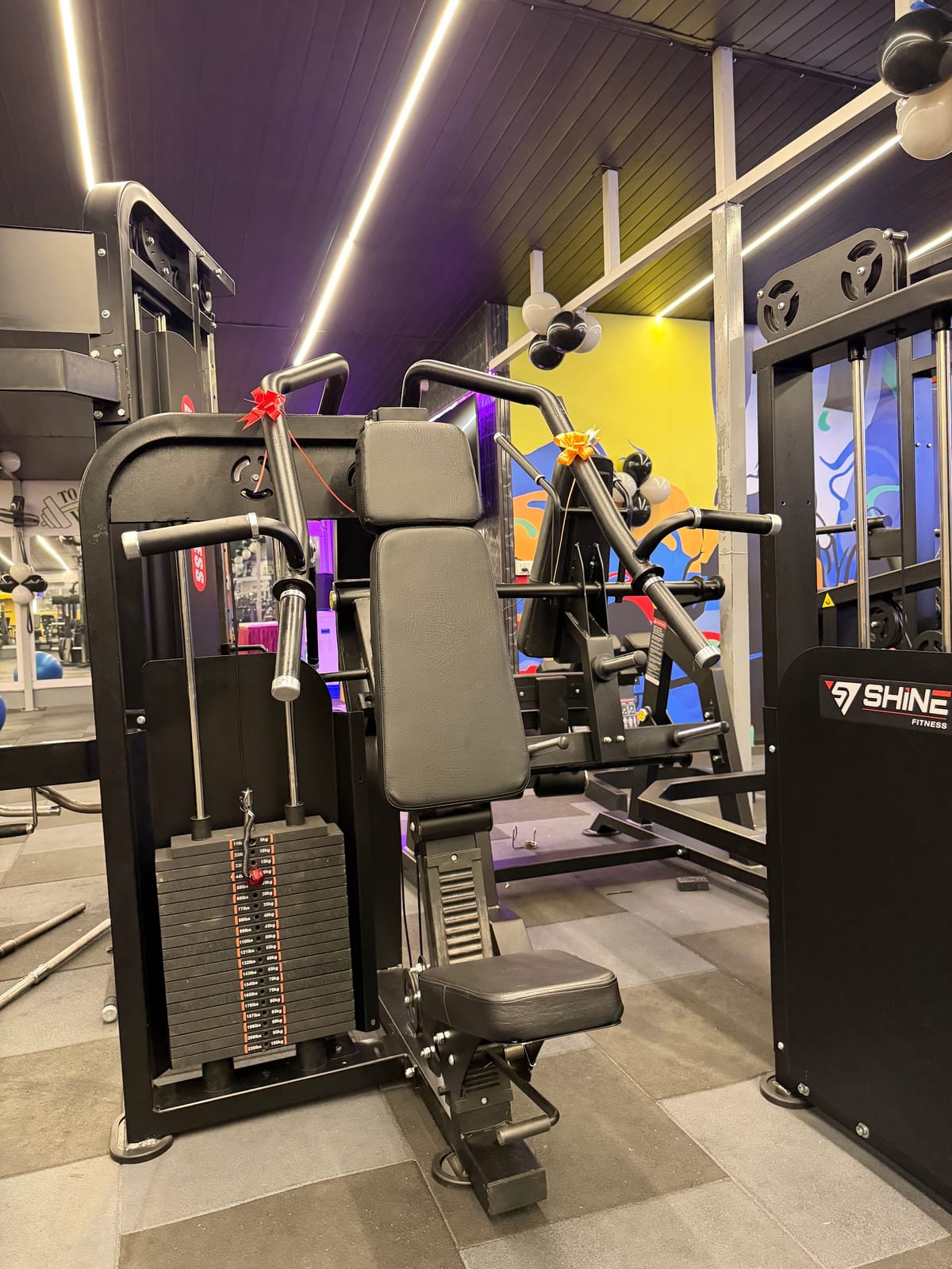 Gym room with cable and weight-training machines at Unique Fitness Gym