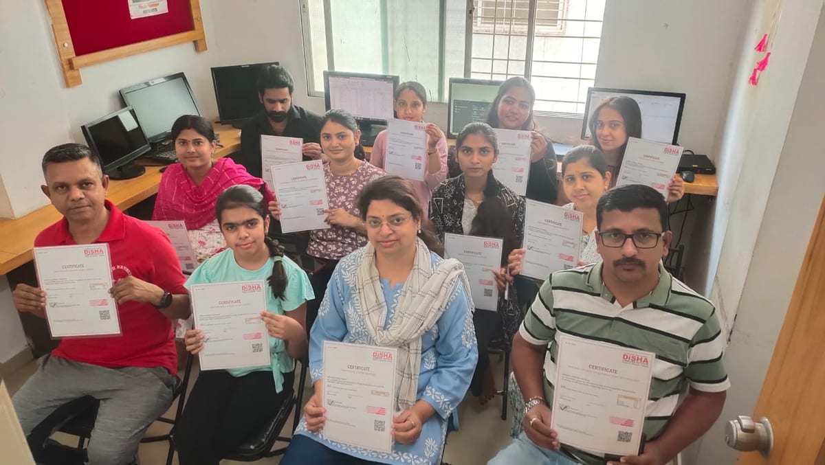 Group seated in an office holding printed course completion certificates