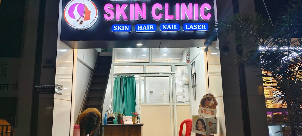 Skin clinic storefront lit at night with the reception visible inside