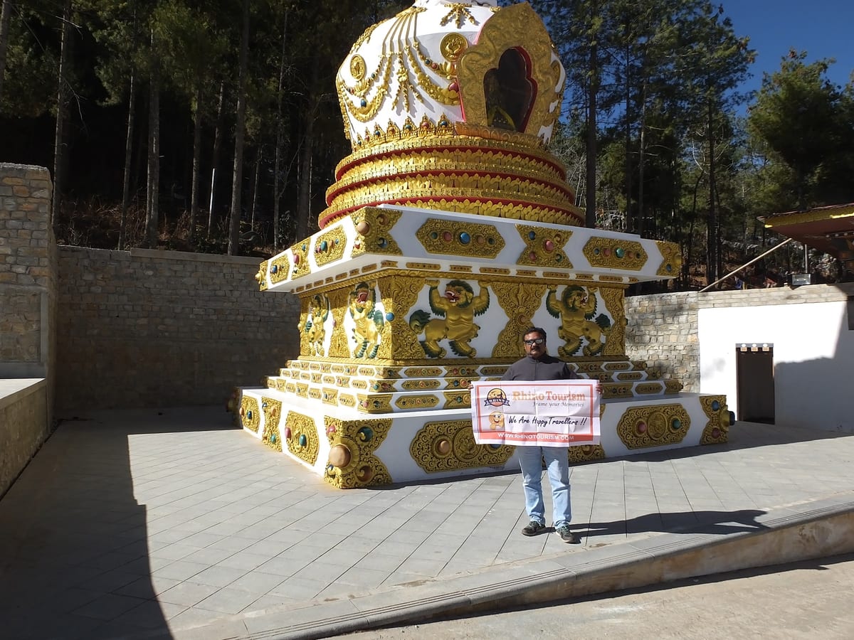 Decorated outdoor monument with a person holding a sign in front