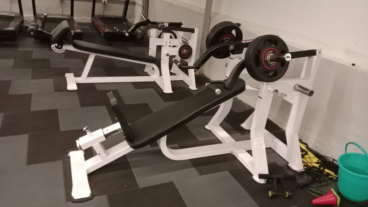 Weightlifting and cardio equipment arranged in a gym room