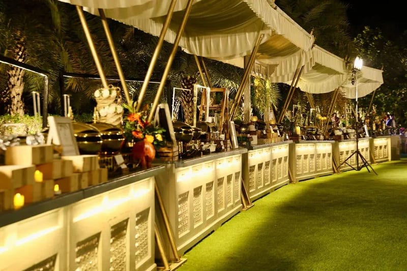 Outdoor buffet counters with covered serving stations at a night event in Nagpur
