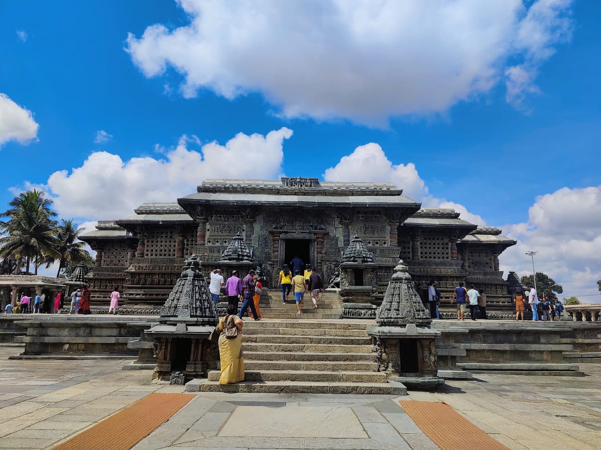 Carved stone temple entrance with visitors on broad front steps