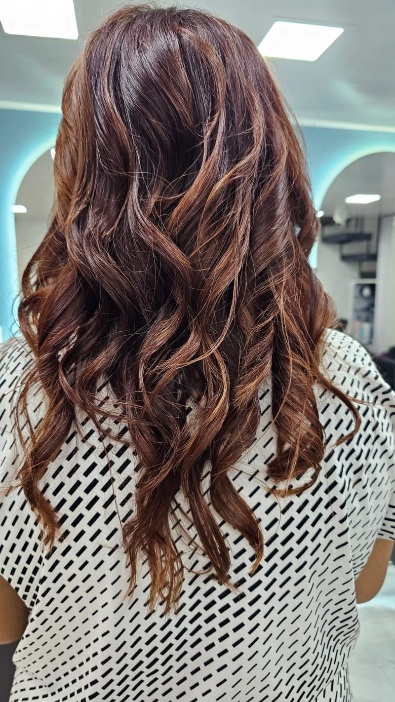 Back view of long wavy brown hair styled at Samir's Salon