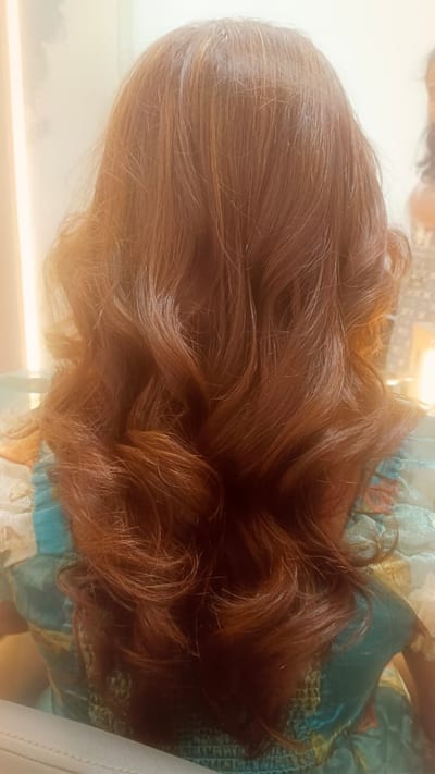 Back view of long wavy auburn hair after styling