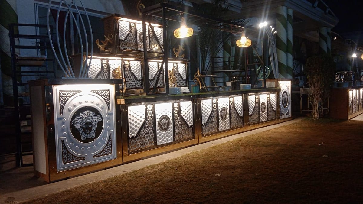 Illuminated ornate outdoor entrance with decorative metal panels at night