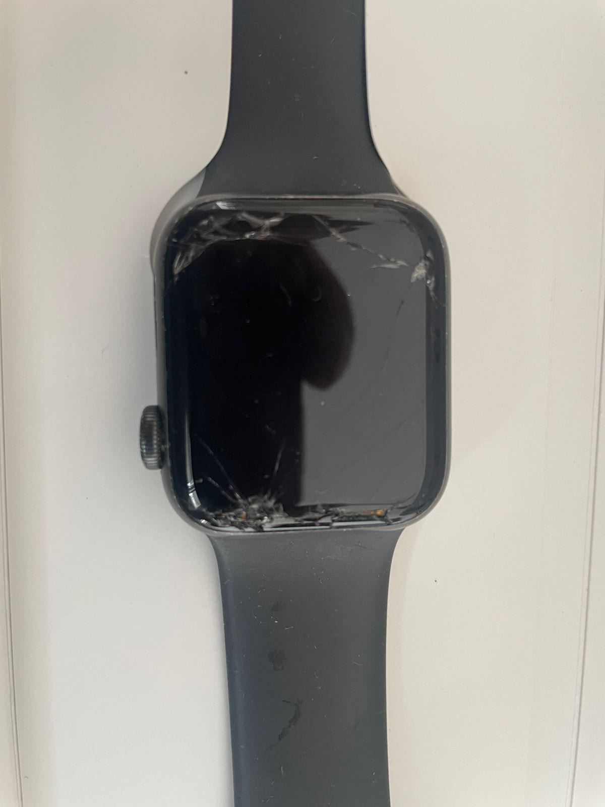 Black smartwatch with a cracked screen and dark band