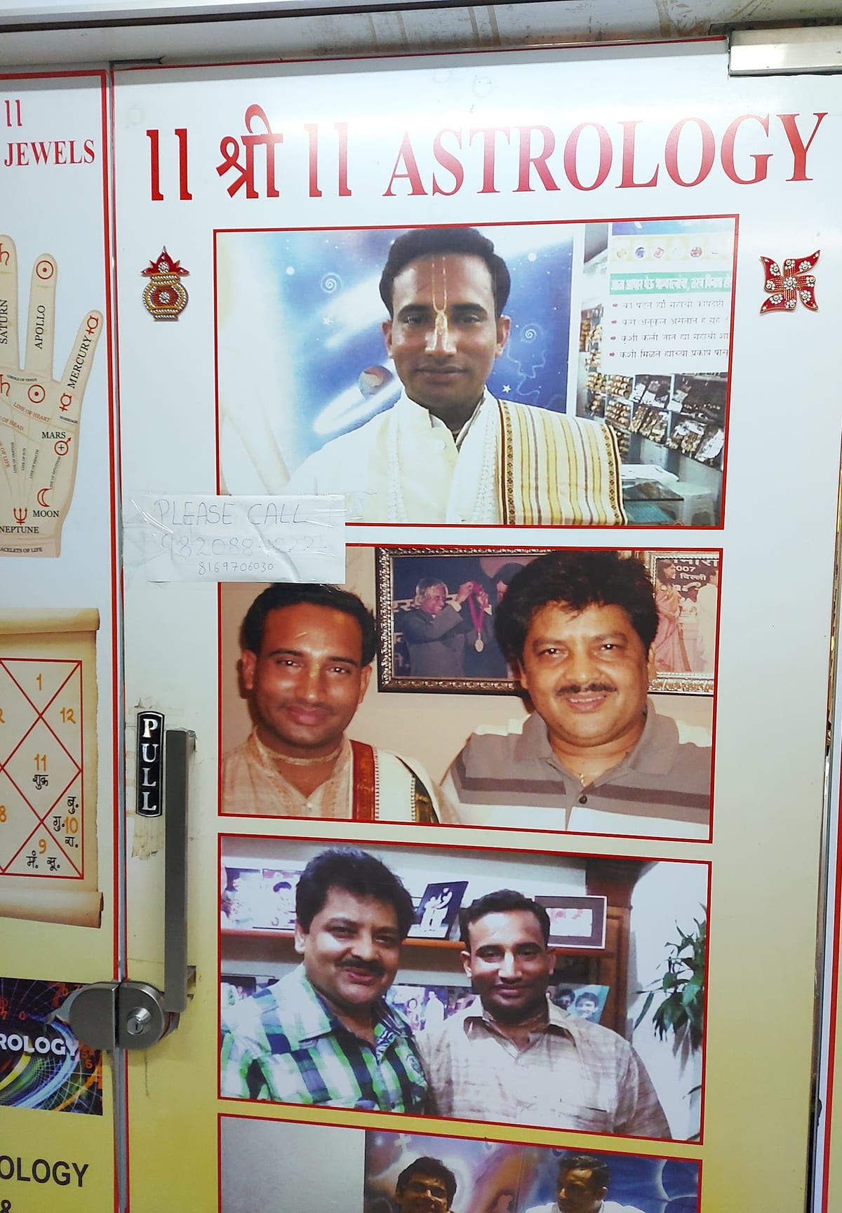Shopfront panel with astrology text, religious symbols and framed photographs