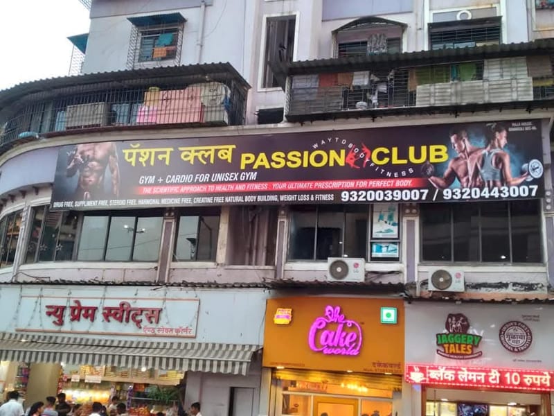 Passion Club gym sign above several storefronts on a multi-storey building