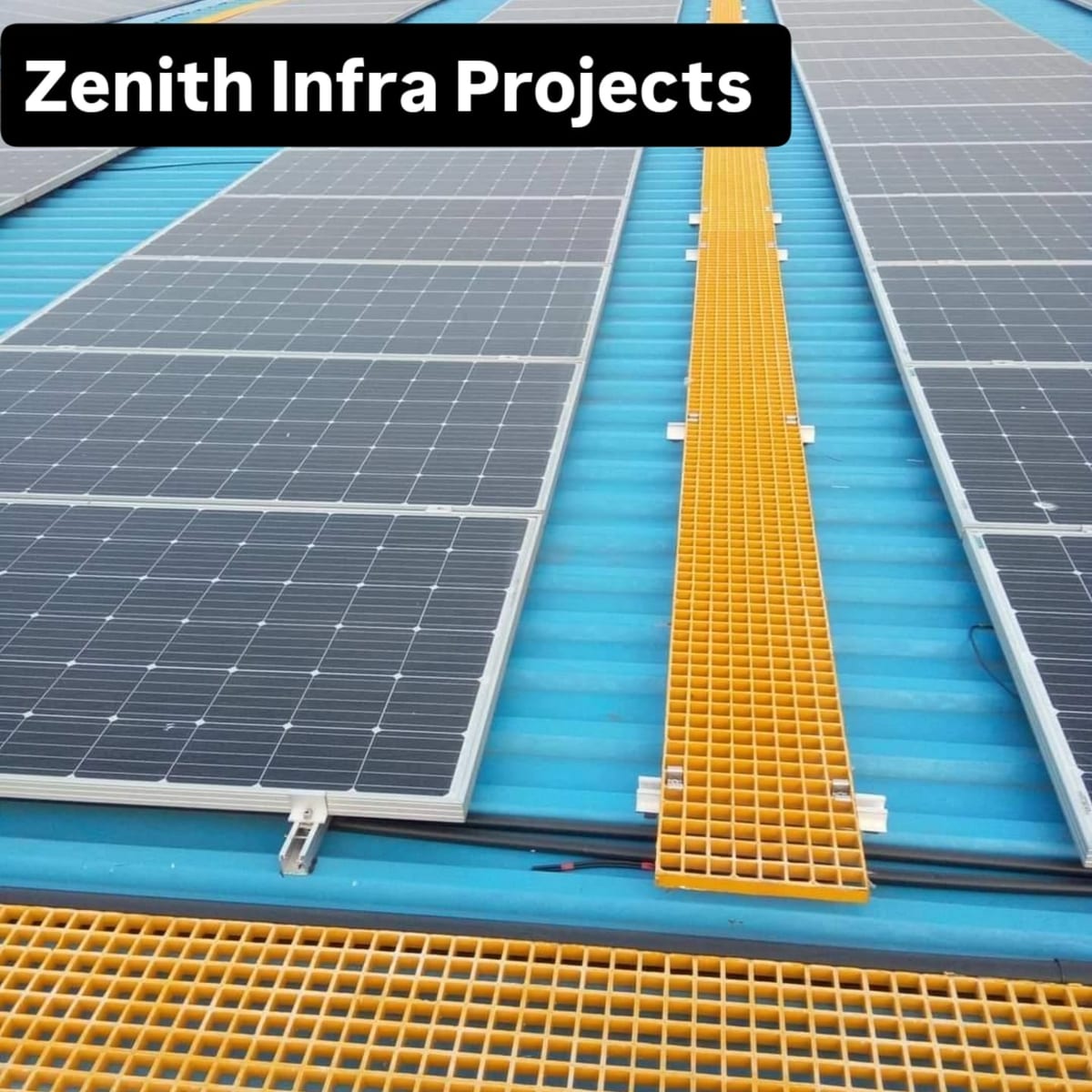 Solar panels on a blue rooftop with yellow access grating walkways