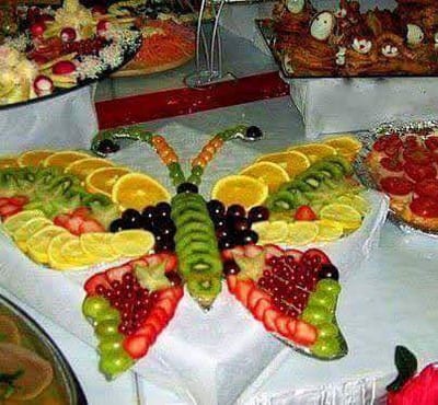 Fruit platters with citrus, grapes, berries and a carved watermelon centerpiece