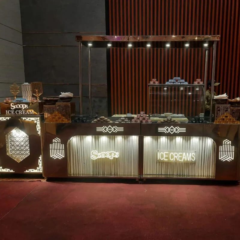 Lit ice cream counter with display cases and decorative panels