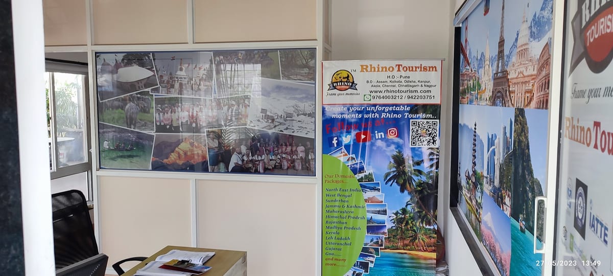 Tourism office interior with travel posters, desk and Rhino Tourism display stand