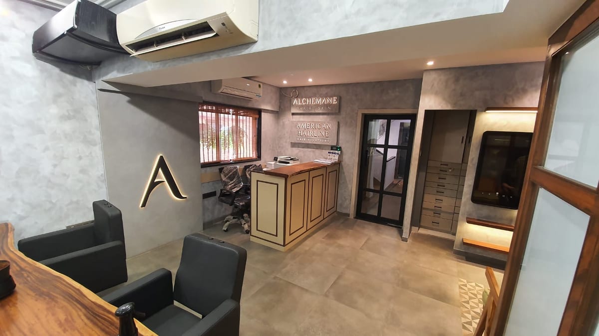 Reception area with a counter, seating, wall lettering and glass doors