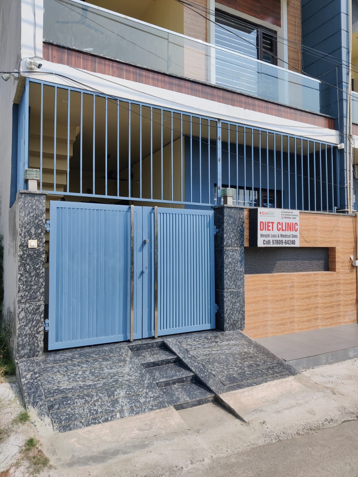 Blue-gated building exterior of DietSmart clinic in Jalandhar with a Diet Clinic sign