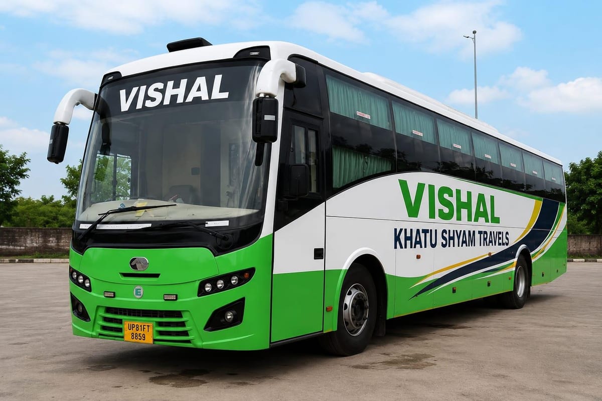 Green and white Vishal Khatu Shyam Travels coach bus