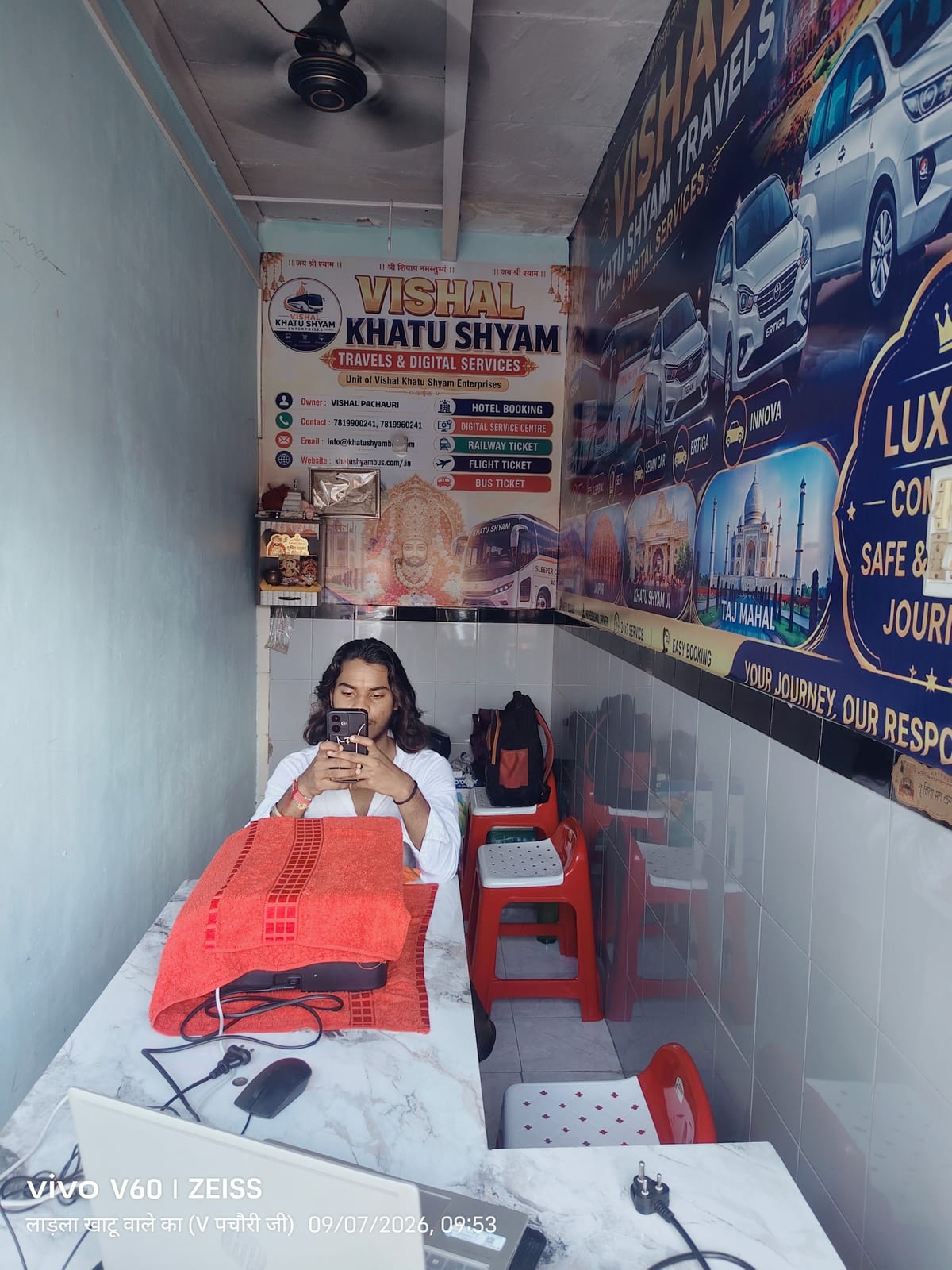 Travel office interior with red chairs, a desk and travel posters in Agra