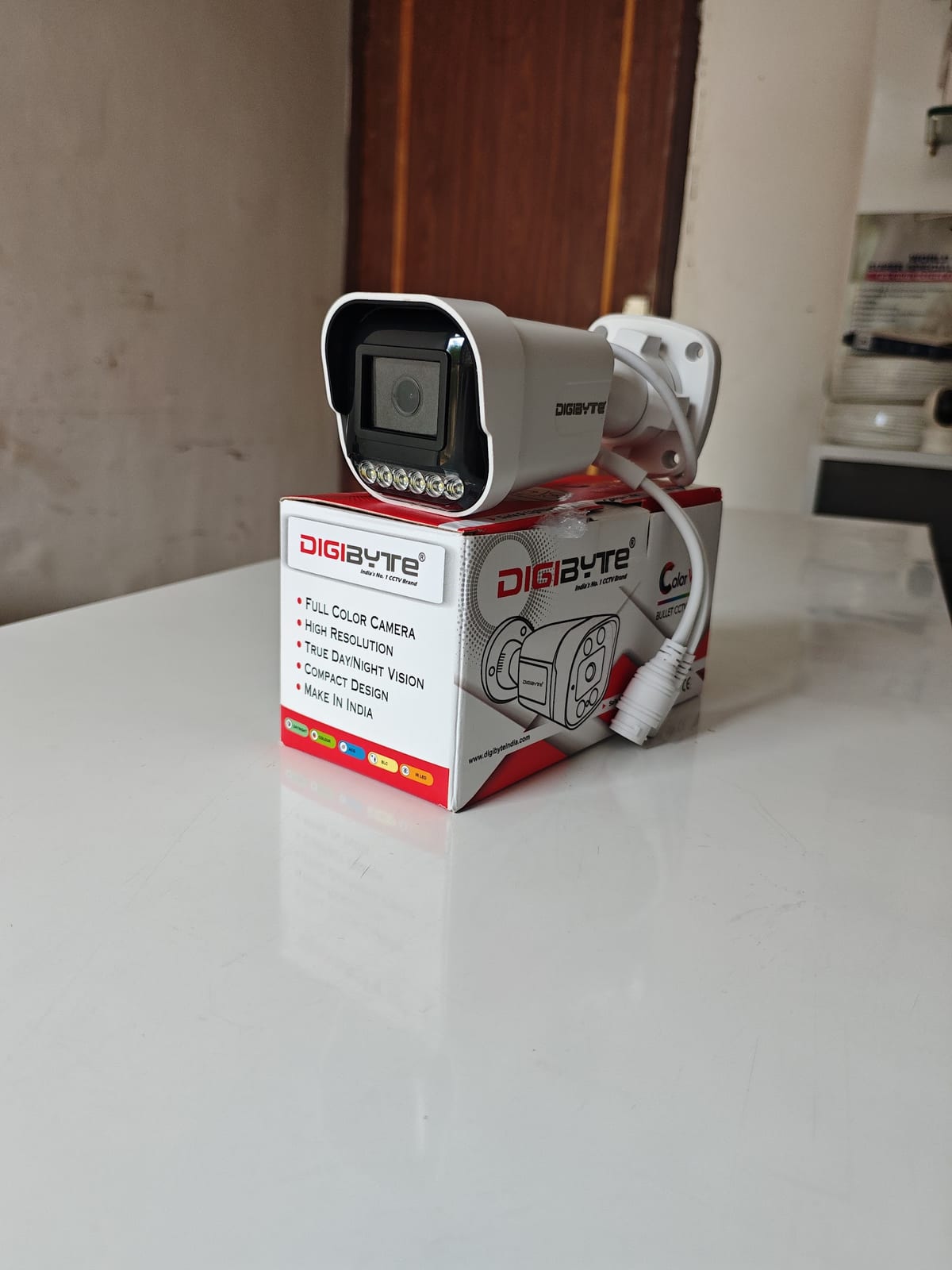 Security camera displayed on its retail box on a white countertop