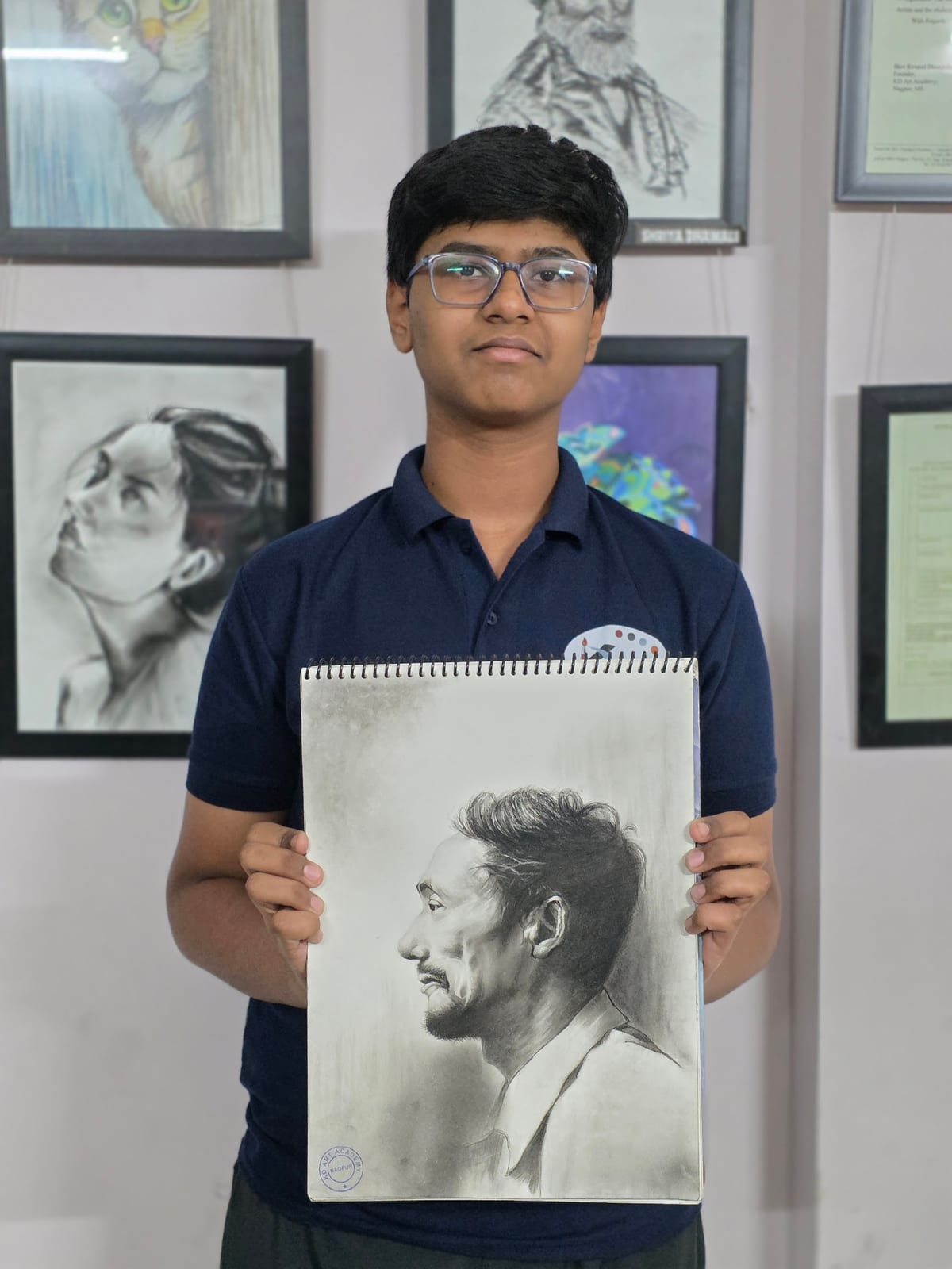 Person holding a spiral-bound sketch of a side-profile portrait